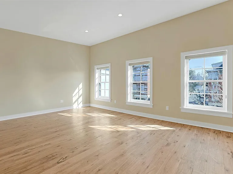 As you enter, you are greeted by a light-filled living space.