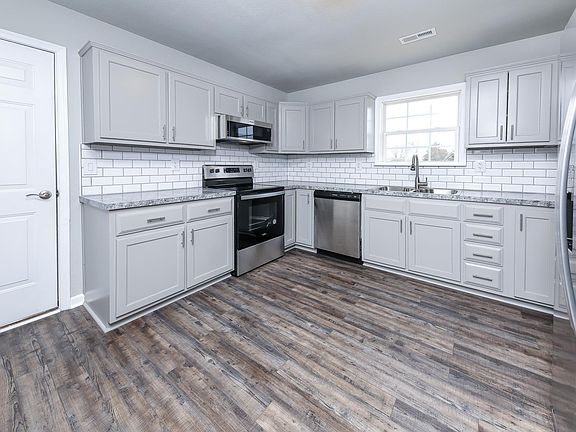 Kitchen with new rustic vinyl plank flooring and backsplash