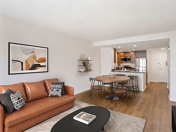 Updated Finishes kitchen, living, and dining area with hard surface flooring