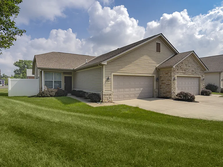 Enjoy the convenience and curb appeal of a home with a spacious driveway and attached garage, perfect for everyday living.