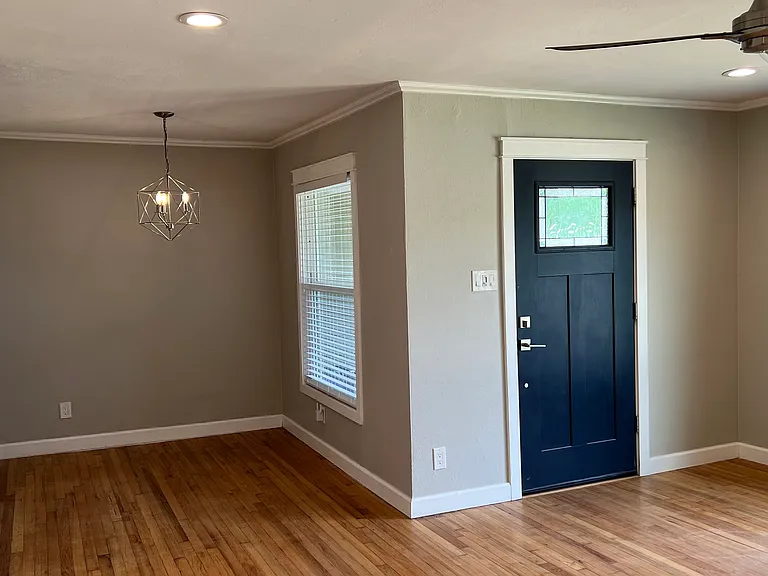 Living room looking towards entry door and dining room
