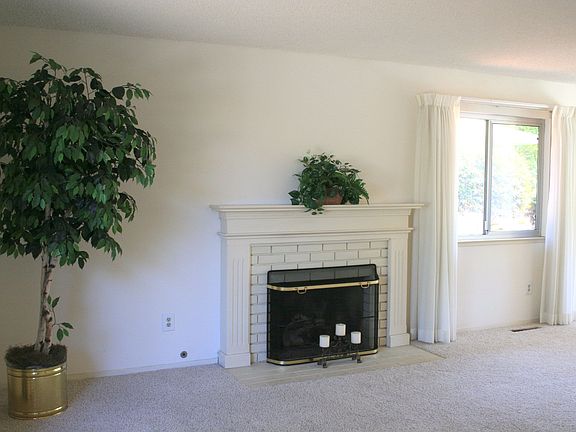 Living room w/fireplace flows into dining area