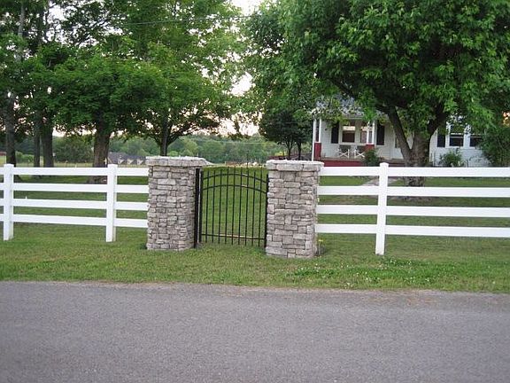 Walking gate w native stone pathway to house