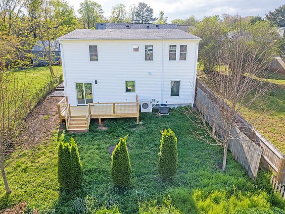 Carriage House - rear view including shared back yard. Deck is private to Unit 100
