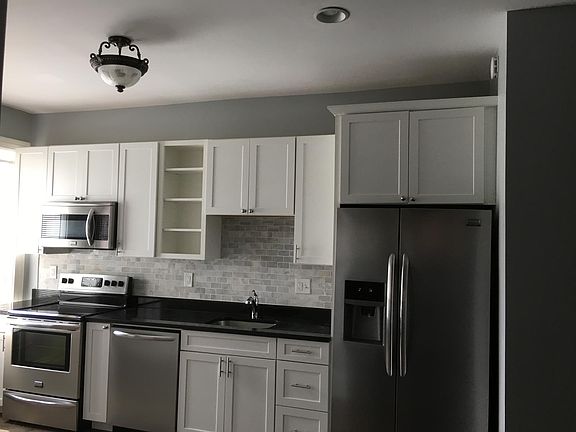 Kitchen with stainless steel appliances, white wood cabinets and lots of cabinet space