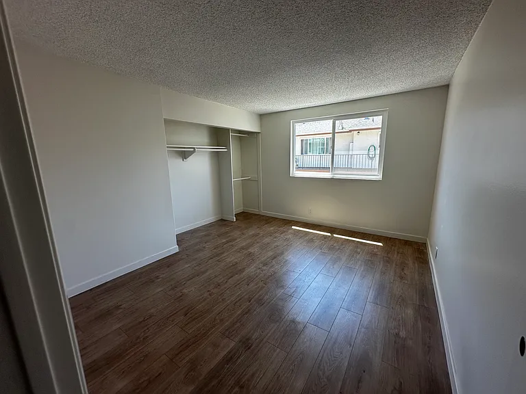 3rd Bedroom w/ Large Closet, photo without new closet doors installed. View shows the natural light and large size of bedroom