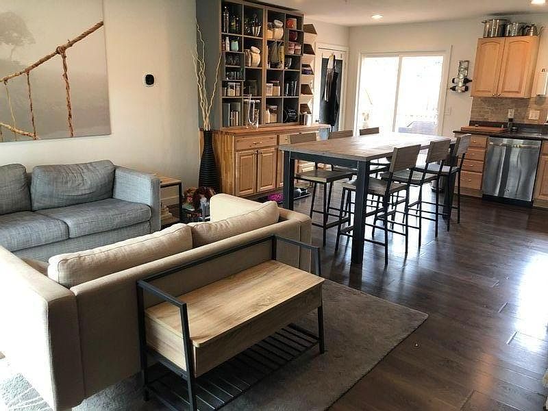 Open concept main level with living area, dining area, and kitchen.