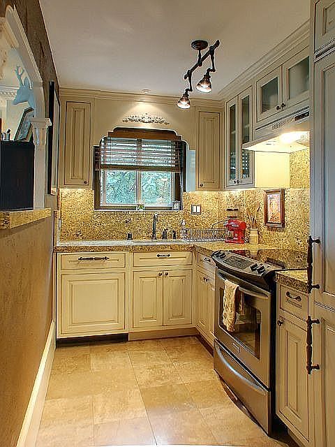 Kitchen: custom cabinetry, granite counters, marble floor, built in appliances