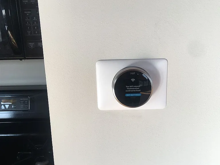 Nest WiFi thermostat for remote temperature adjustment and energy savings