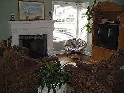 Custom mantel, crown molding and hardwood floors in the family room