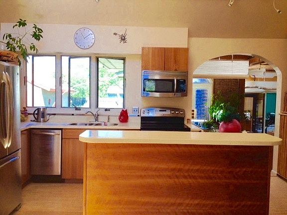 Kitchen with cork floors and stainless steel appliances