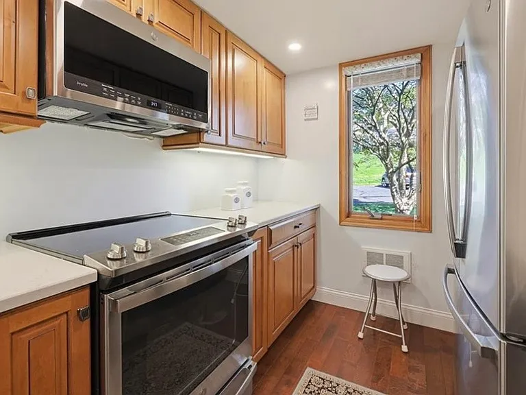 Kitchen with a view of trees and grass meadow