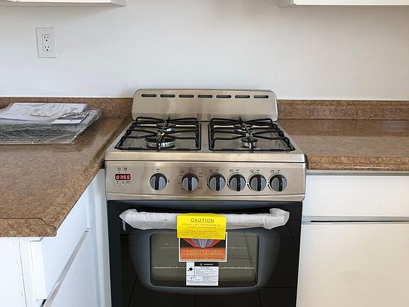 Brand new stainless steel gas range with matching vent that actually vents to the outside.