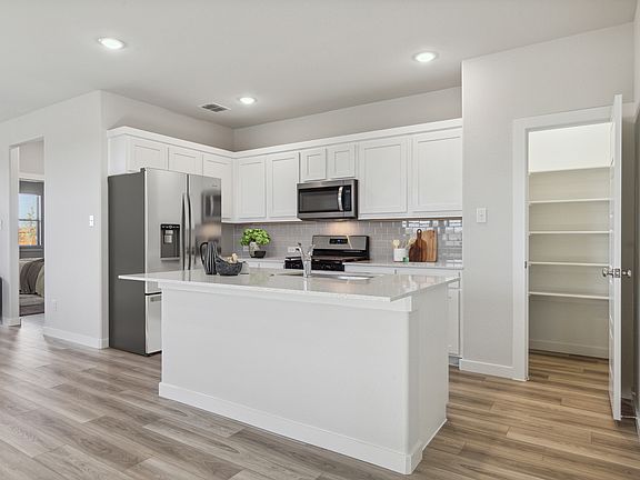 Kitchen in the Willow home plan by Trophy Signature Homes - REPRESENTATIVE PHOTO