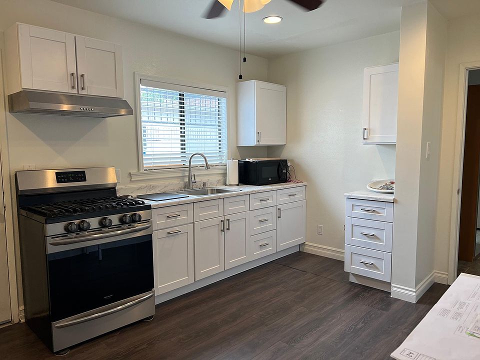 Brand new kitchen cabinets. Stainless steel stove and hood.