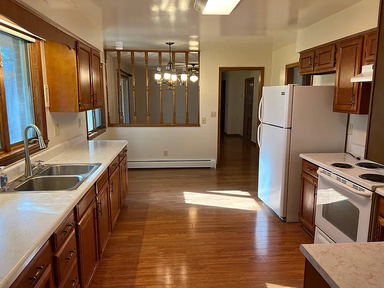 Kitchen showing eat in area with space for table with 4-5 chairs, light overhead