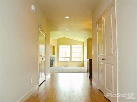 Wide entry hallway to main entrance and guest bedrooms.