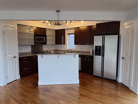 Kitchen has all modern appliances with breakfast bar island and plenty of counter, cabinet and pantry space.