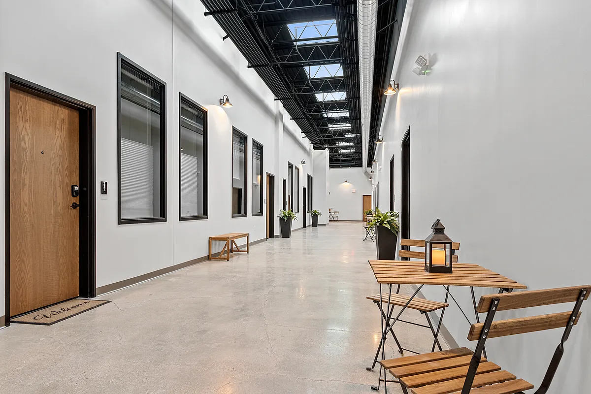 Our halls do more than connect- you can lounge, laugh, sip, and stay. Sunlight included. - City Center Lofts