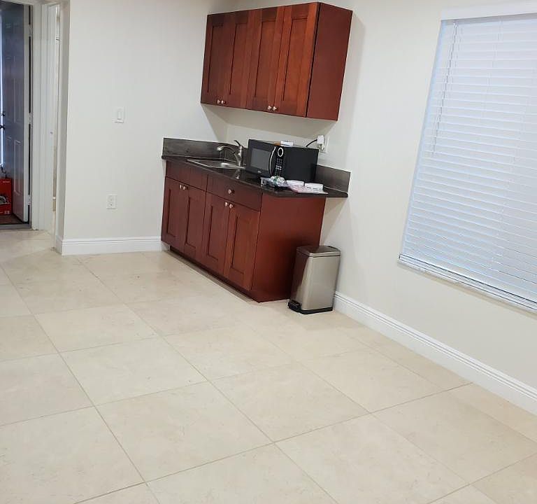 Kitchenette area with full fridge and microwave