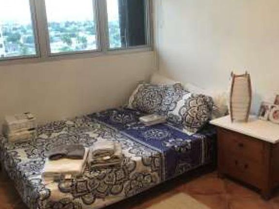 The master bedroom has ample closet space and city views from the 10th floor