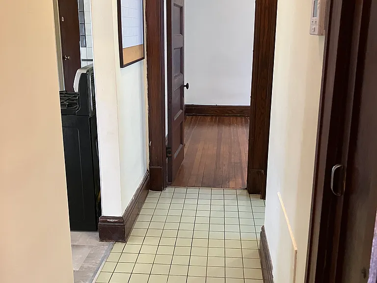 Bath and bedroom hallway - facing door open to bedroom off of kitchen