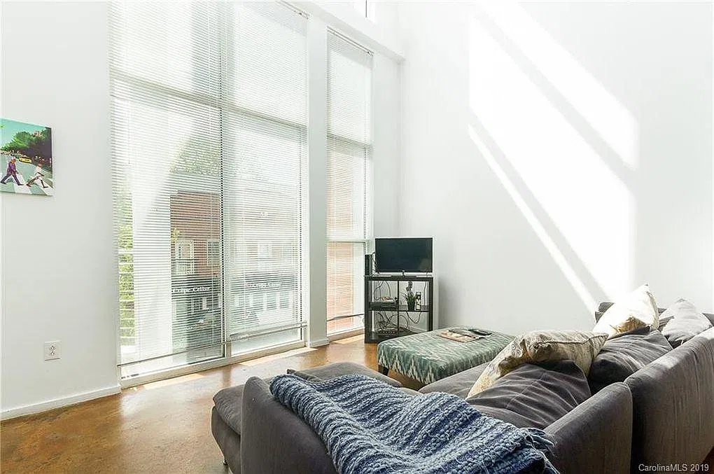Lots of natural light beams into these 20' ceilings and blinds as well for darkness and privacy when necessary.