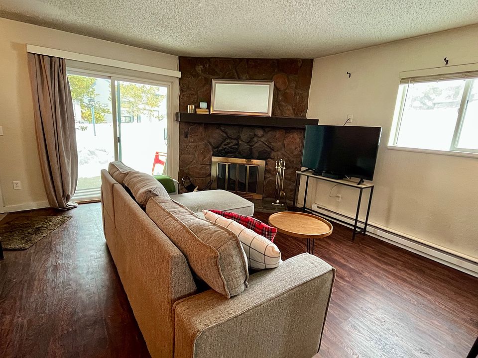 Living room, fireplace, and sliding doors to patio.