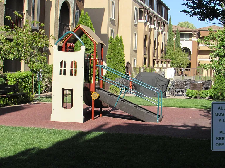 BBQ patio with outdoor dining sets and play area