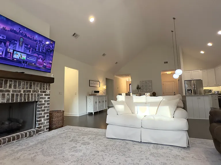 Living room with fireplace and mounted television
