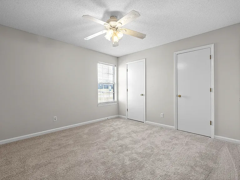 Bedroom with wall-to-wall closets