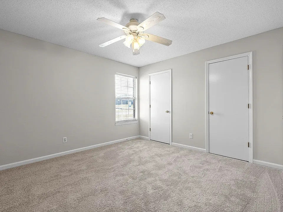 Bedroom with wall-to-wall closets