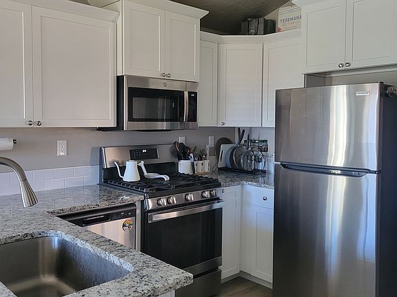 Quartz countertops and stainless appliances.