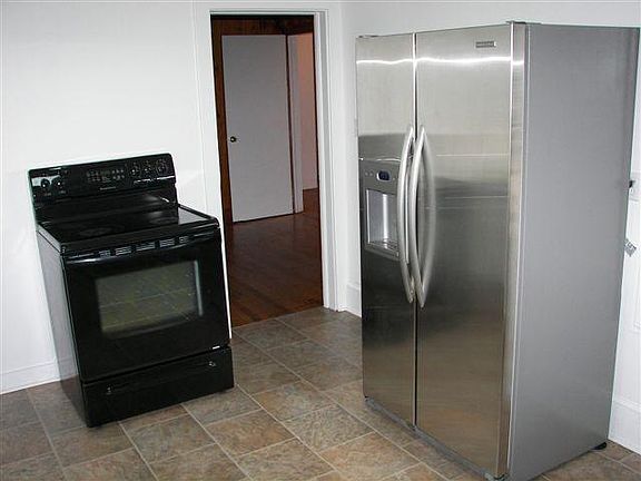 Glass Top Stove and Stainless Double Door Refrigerator.