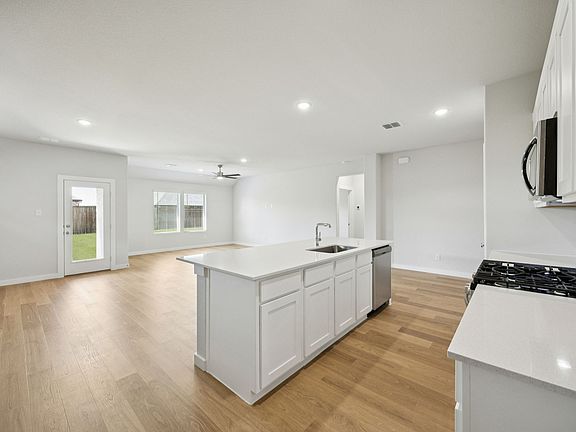 Kitchen in the Heisman home plan by Trophy Signature Homes - REPRESENTATIVE PHOTO
