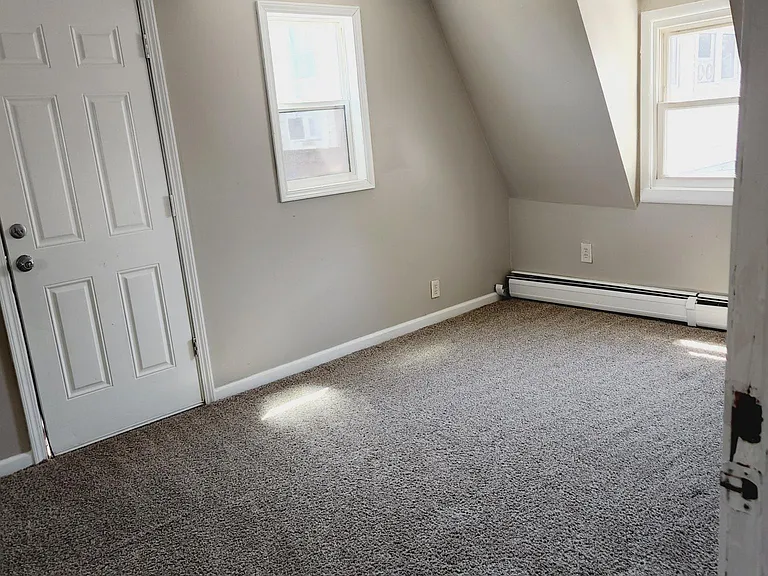 upstairs bedroom connecting to the front porch. Carpet is very plush.