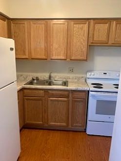 Kitchen with stove and refrigerator