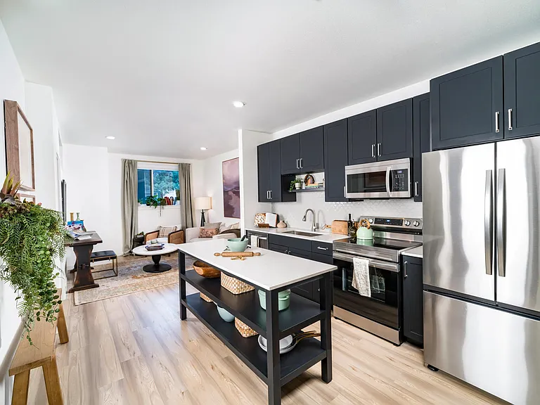 An open kitchen with a central island at Modera University Park, offering multiple finish options to choose from.