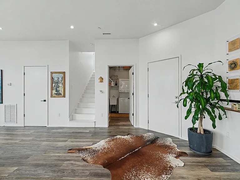 Stairs leading to primary bedroom and rooftop patio