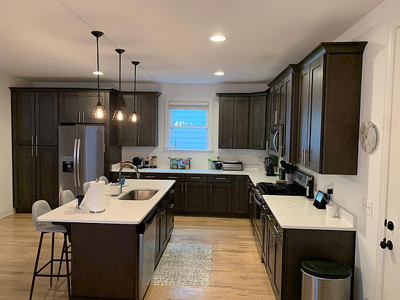 Kitchen with quartz countertops and stainless steel appliances.