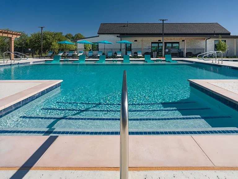 Resort-style swimming pool with lounge seating
