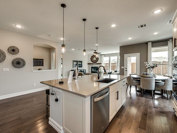 Spacious kitchen with pendant and recessed lighting