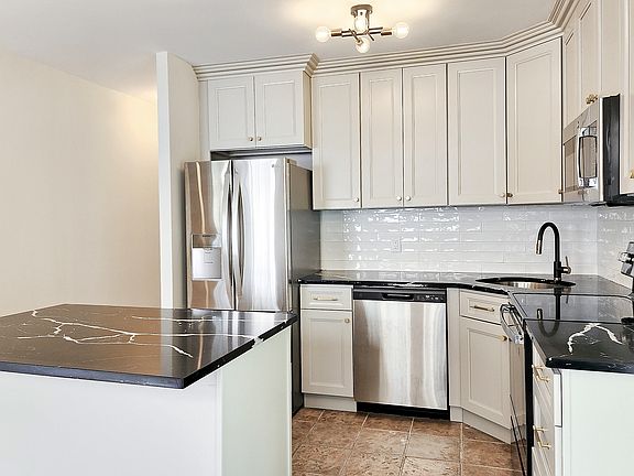 Brand-new kitchen with new stainless steel appliances, large island and quartz counter tops.