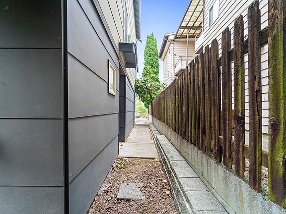 Walkway to the main entry and fenced pocket patio
