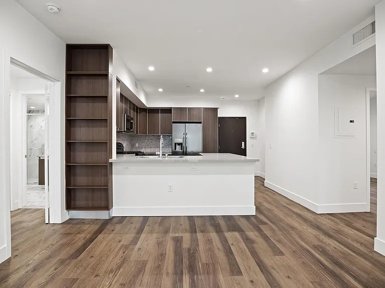 Kitchen and Dining Space with Countertop Bar and Built-In Shelving