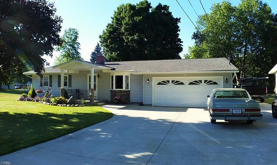 New porch with composite decking and stone & wood columns. Newer insulated garage door. Triple wide concrete drive.
