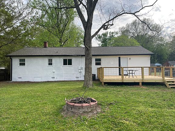 Wide open backyard with big shade trees and a Huge New deck.