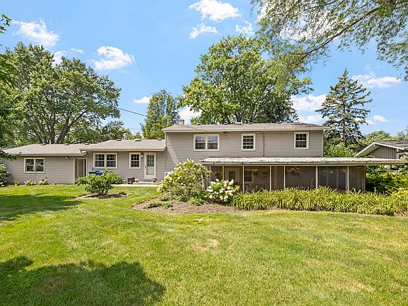 View of large backyard & outdoor covered patio, fully landscaped.