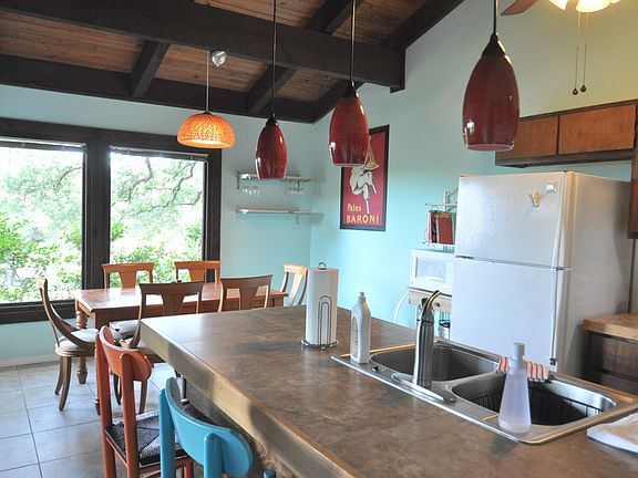 tile counters with bar in fully furnished kitchen