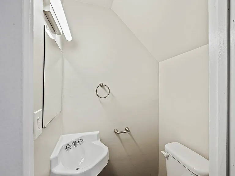 Experience the elegance of a compact modern bathroom designed for efficient use of space.